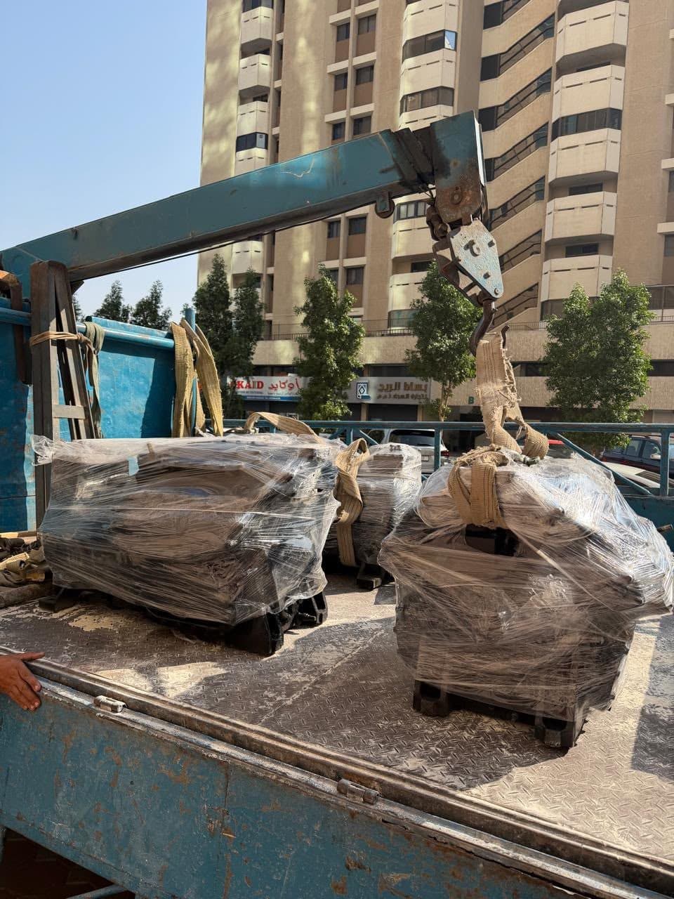 Wrapped equipment loaded on a crane truck for delivery