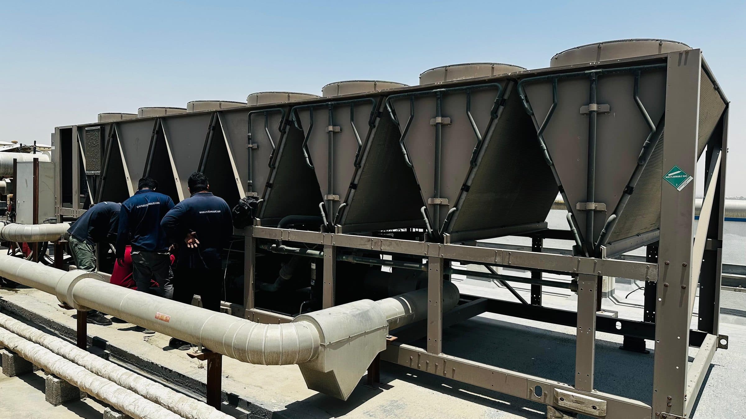 Technicians servicing a rooftop chiller plant
