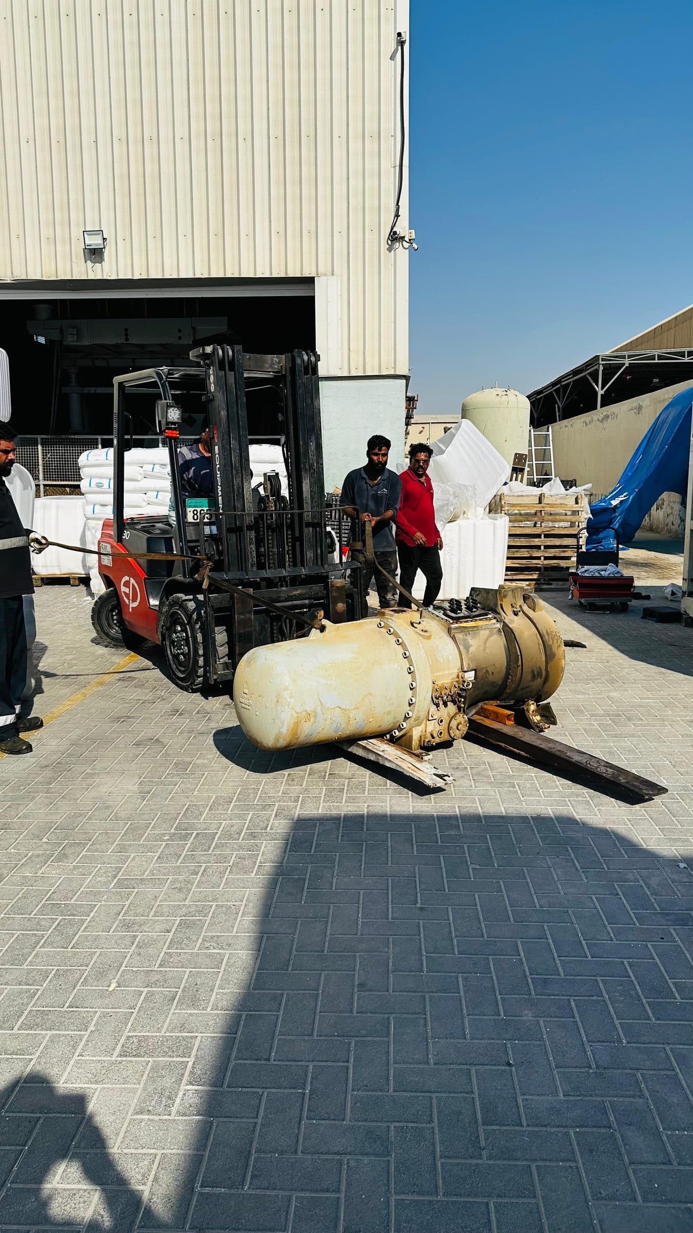 Screw compressor being handled by forklift at the Arctic Mount yard