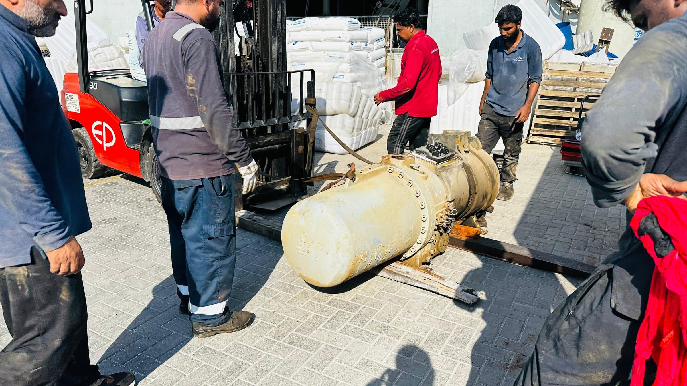 Screw compressor being moved on the Arctic Mount workshop yard