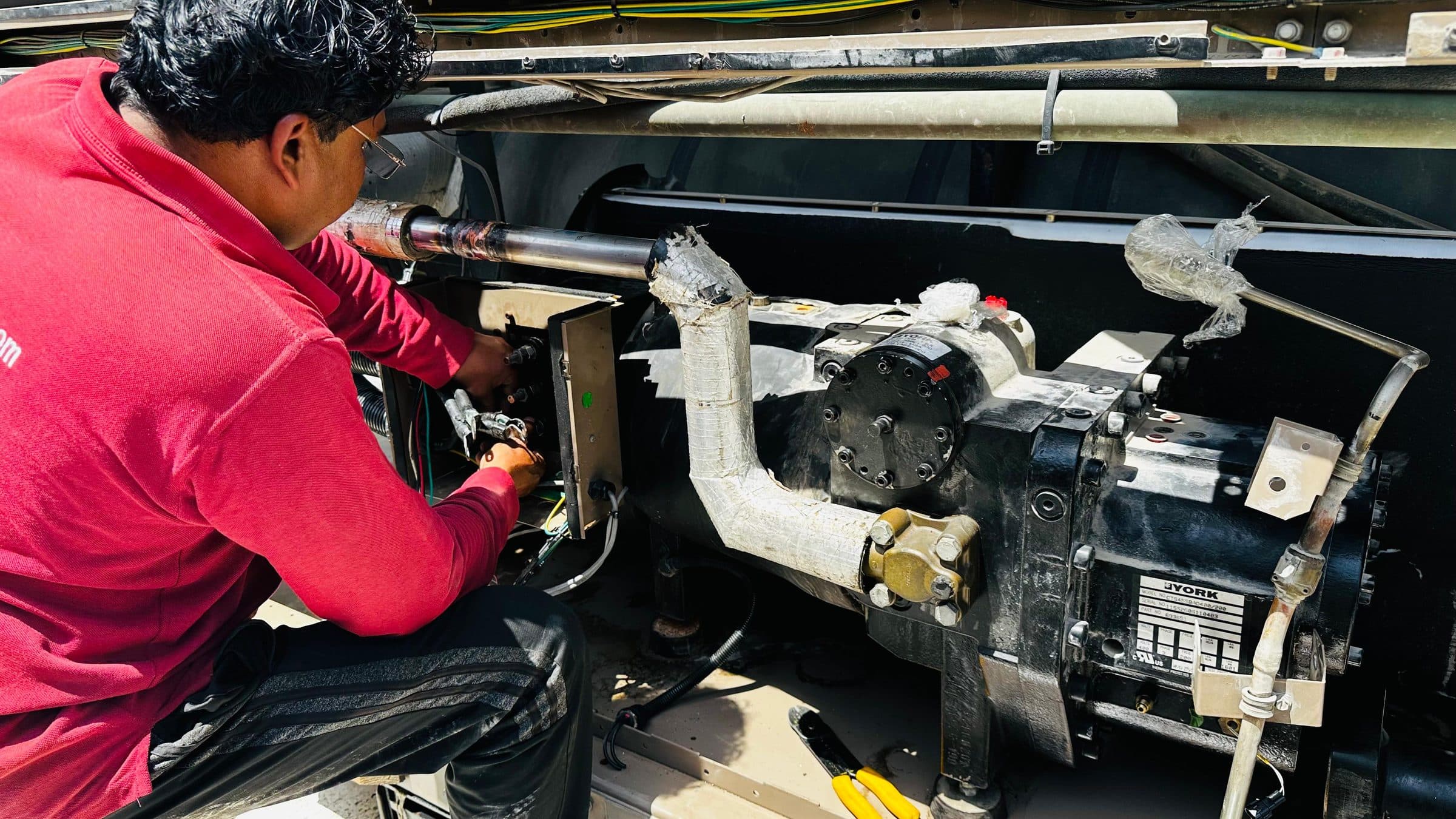 Technician working on a York screw compressor