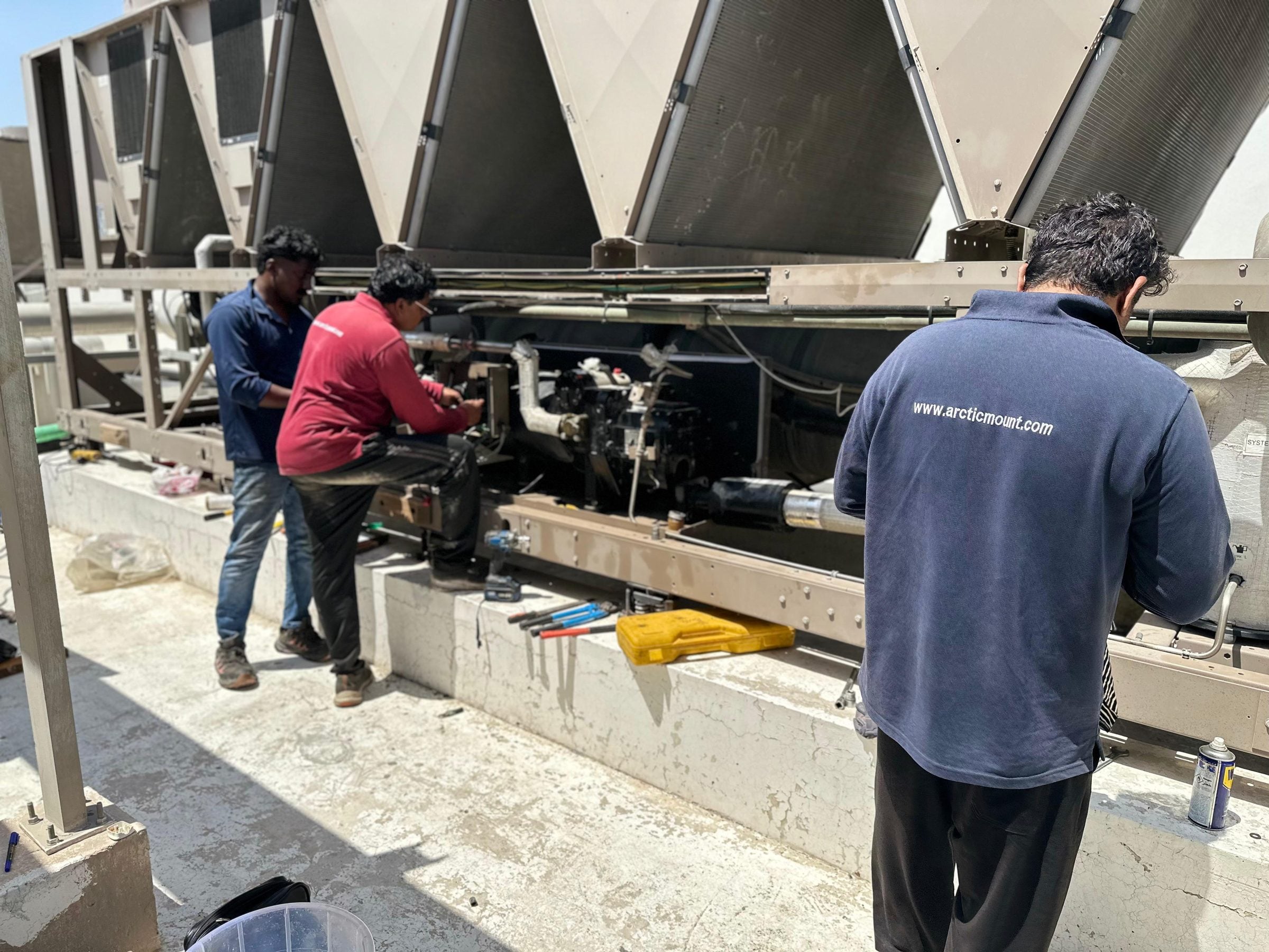 Arctic Mount technicians working on a chiller compressor